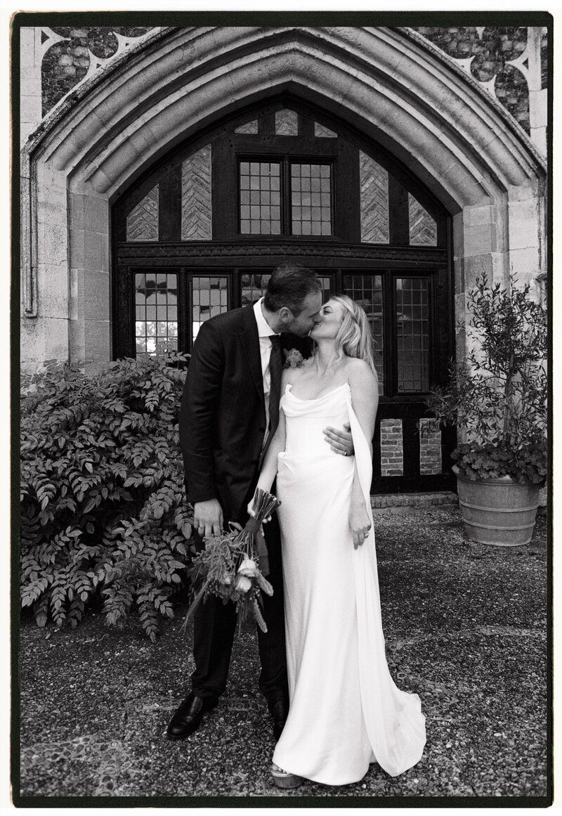 Wedding photographer captures couple taking a stroll hand in hand at their french chateau wedding.