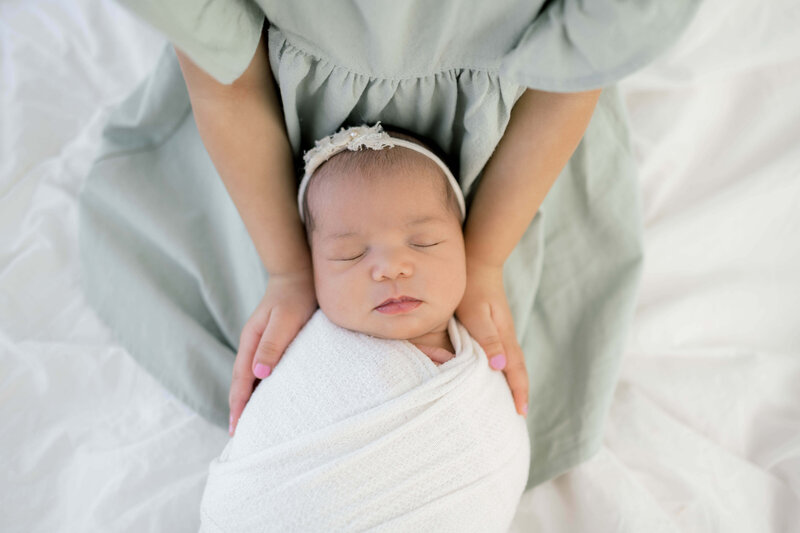 Baby reaching for feet, dimpled baby hands, triangle print blanket