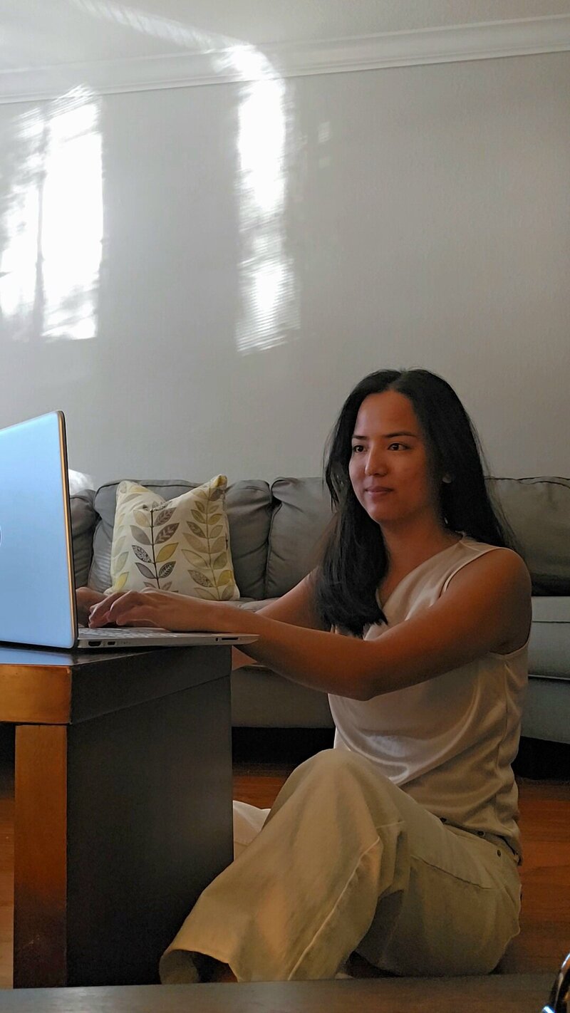 Emily working on laptop doing website design in jacksonville fl