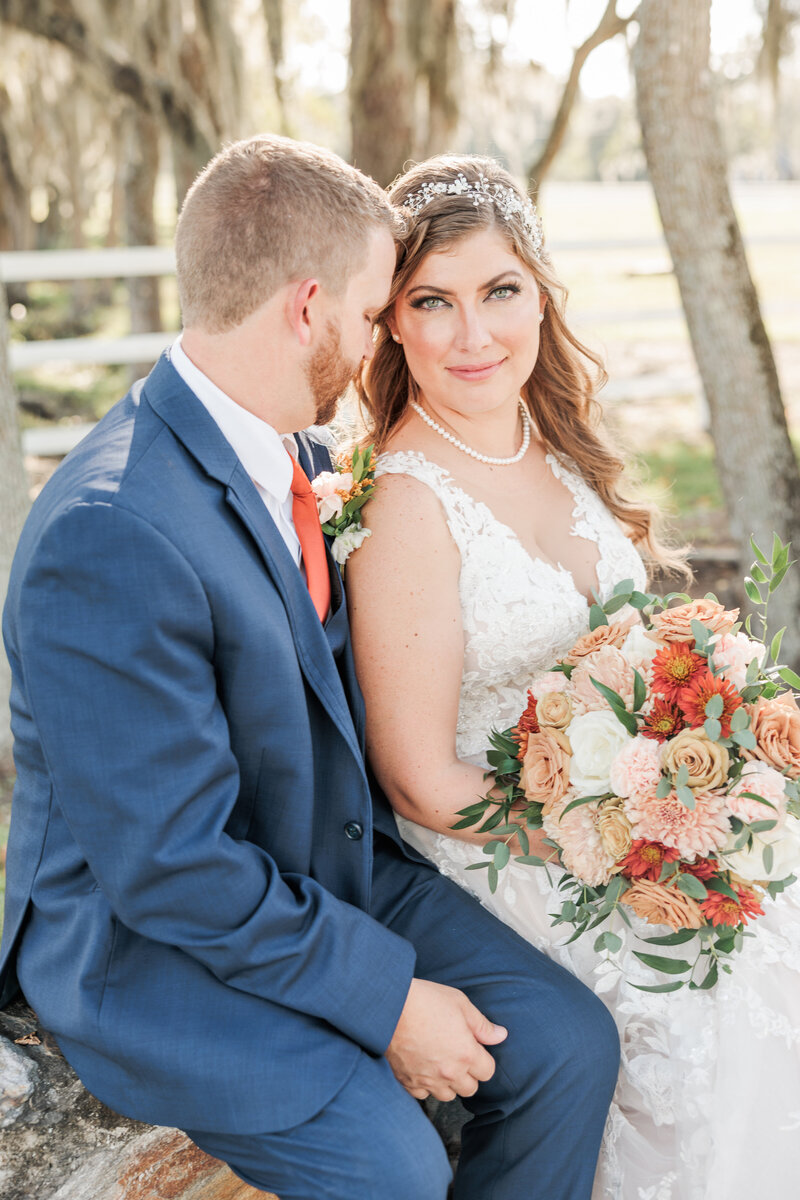 Bride smiling and twirling in wedding dress in a field
