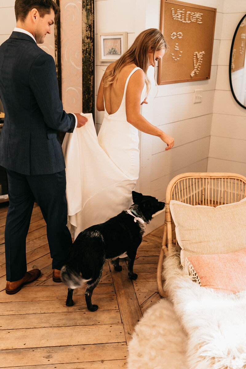 An intimate moment inside an Atlanta treehouse Airbnb during an elopement. The bride and groom are accompanied by their dog, capturing the warmth of their special day.