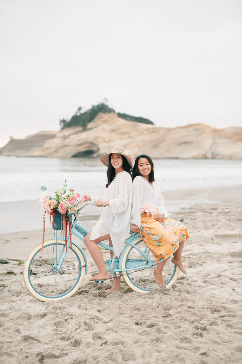 Whitney and Matsaya on a bike at the beach
