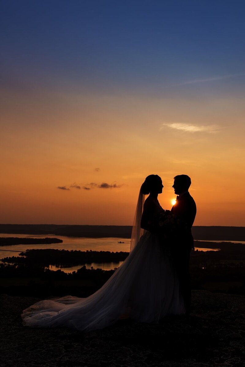 Silhouette of a bride and groom at sunset