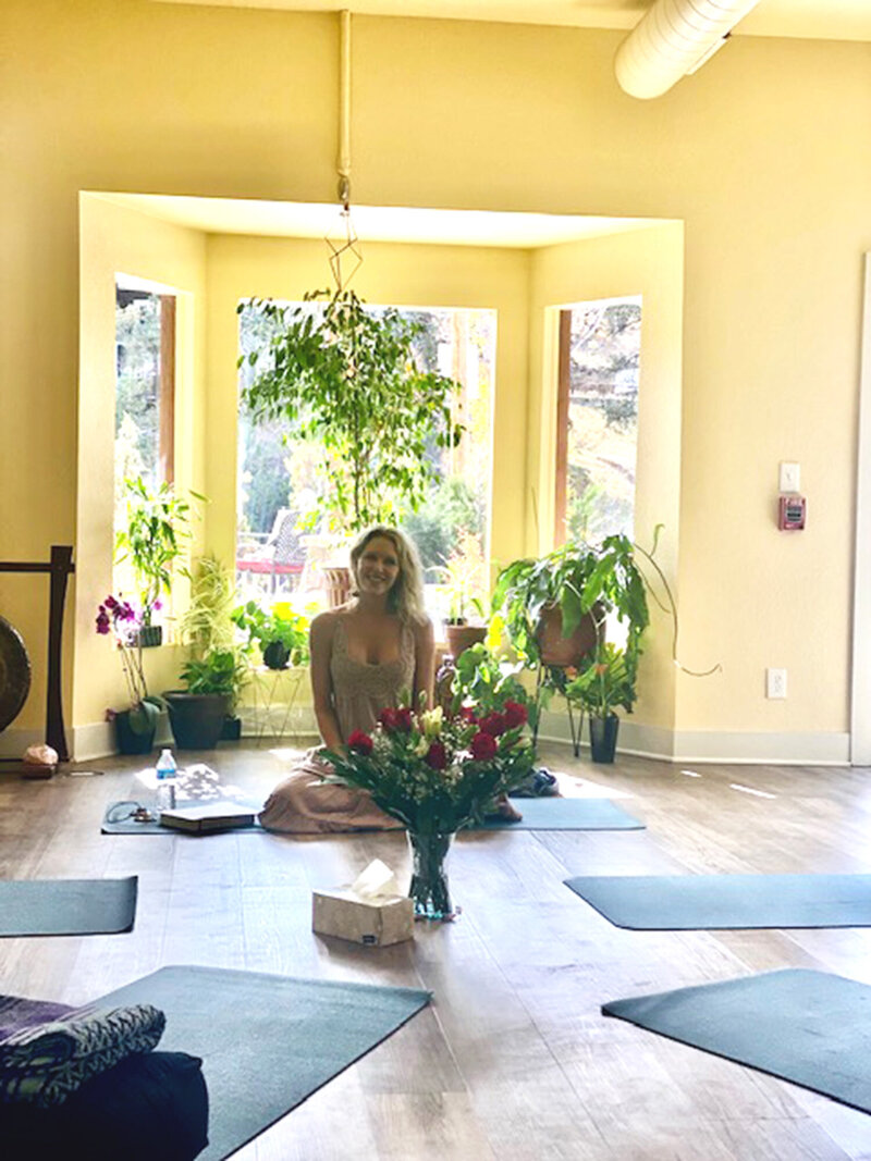 Kathryn sitting in yoga studio