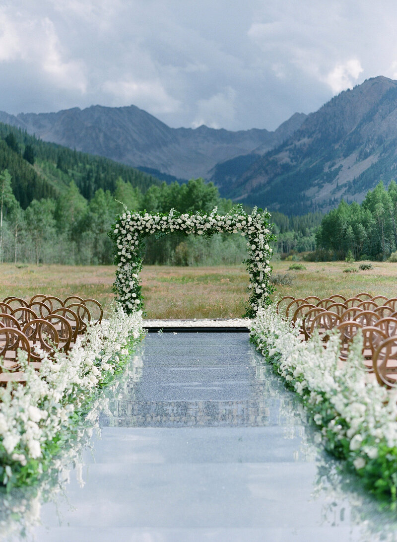 Floral arbor wedding arch at an outdoor mountain venue