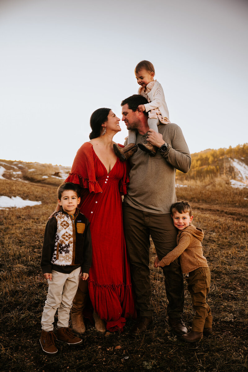 A family of 5 enjoying each other while playing in the Rocky Mountains in Bellvue Colorado