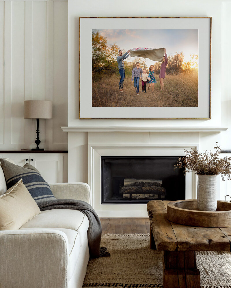 A luxury designer home in Oklahoma City has a family photograph displayed above their fireplace.