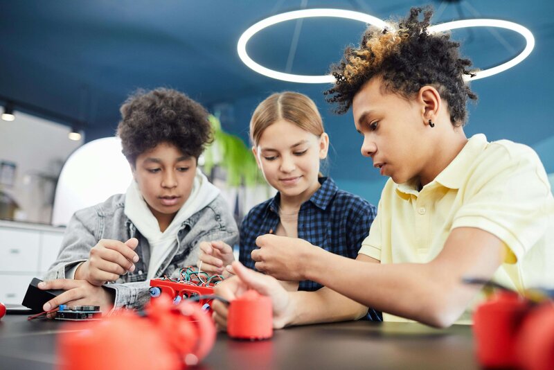 three teenagers working on a group project