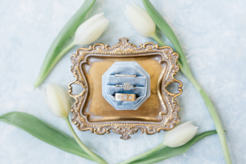 A Wedding Ring Set in a dusty blue ring box at the Alfond Inn.