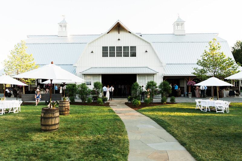 Exterior photo of Wildflower On Watts' white barn venue