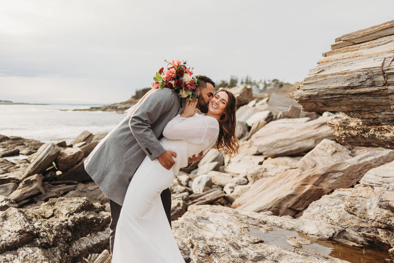 bride and groom kissing on beach