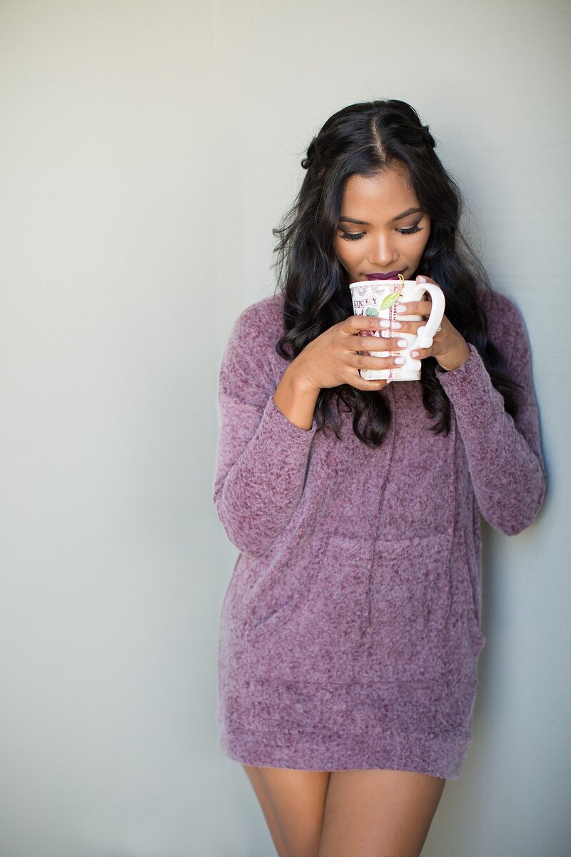 Cozy lifestyle branding photo of woman in a mauve sweater holding a mug, ideal for wellness or self-care entrepreneurs