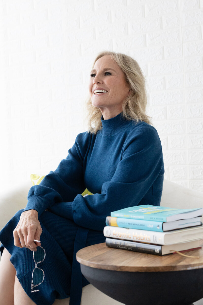 Sitting with books Life Coach Stacey Cauvin