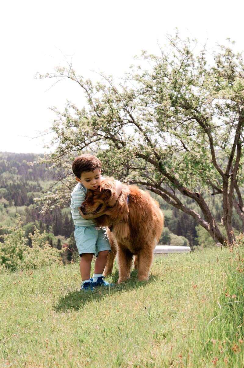 Best friends, a boy and his dog hugging during their cape breton family photo session