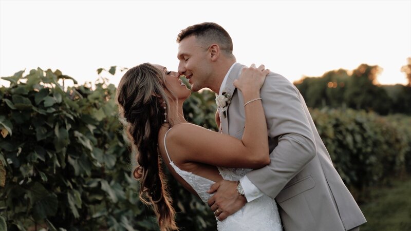Couple kisses in a vineyard after getting married