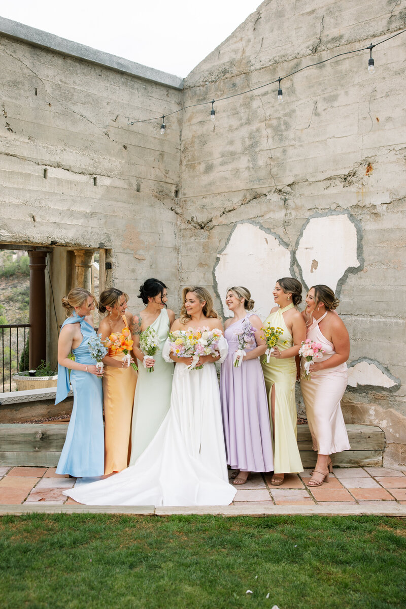 Colorful bridesmaid dresses and matching micro bouquets for a spring wedding at The Little Daisy in Jerome, Arizona designed by Snapdragon Bloom Bar.