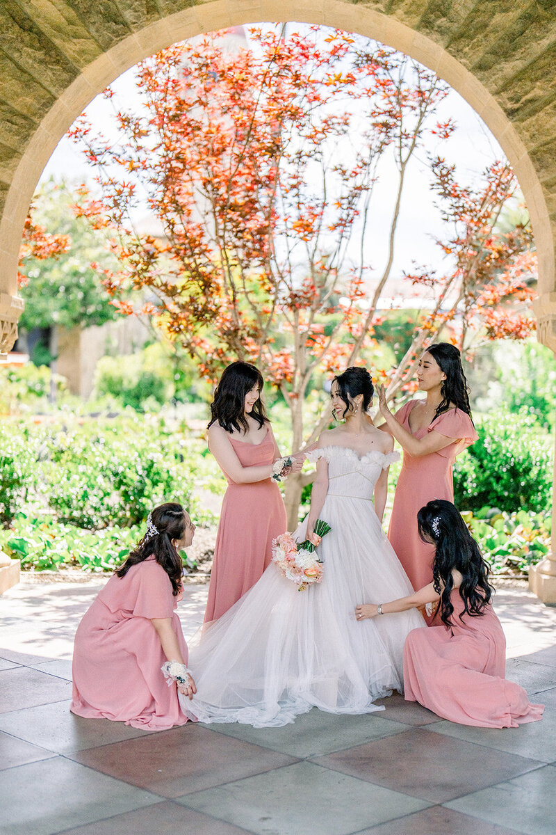 Tiffany Longeway Photography captures a stunning bridal party moment at Villa Montalvo in Saratoga, California. The bride, surrounded by her bridesmaids in a picturesque garden setting, reflects the elegance and beauty of this historic venue. Perfect for couples seeking a sophisticated and scenic location for their wedding day.