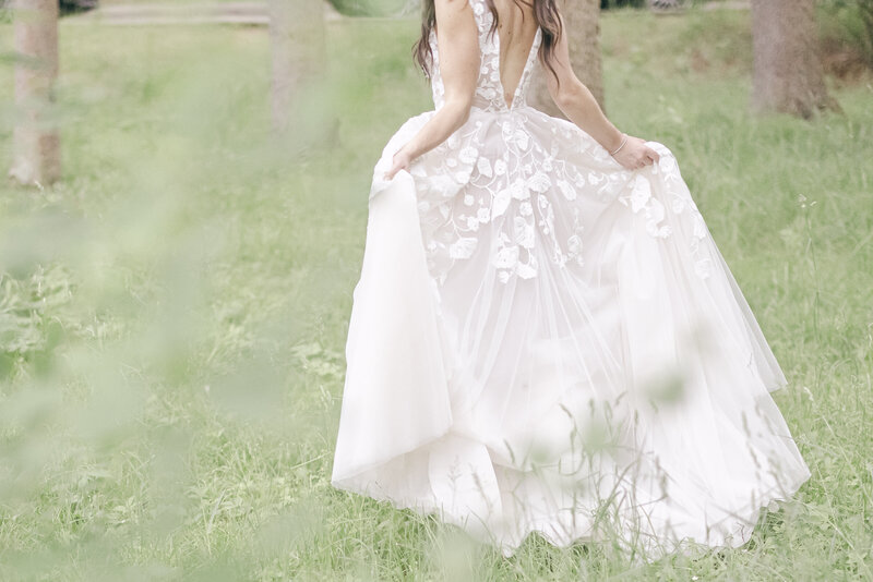 high end bride walks away fanning out her dress showing all the gorgeous detail