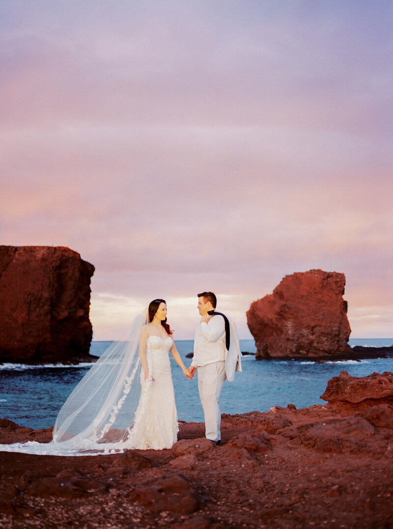 Bride and groom sweetheart rock sunset lanai