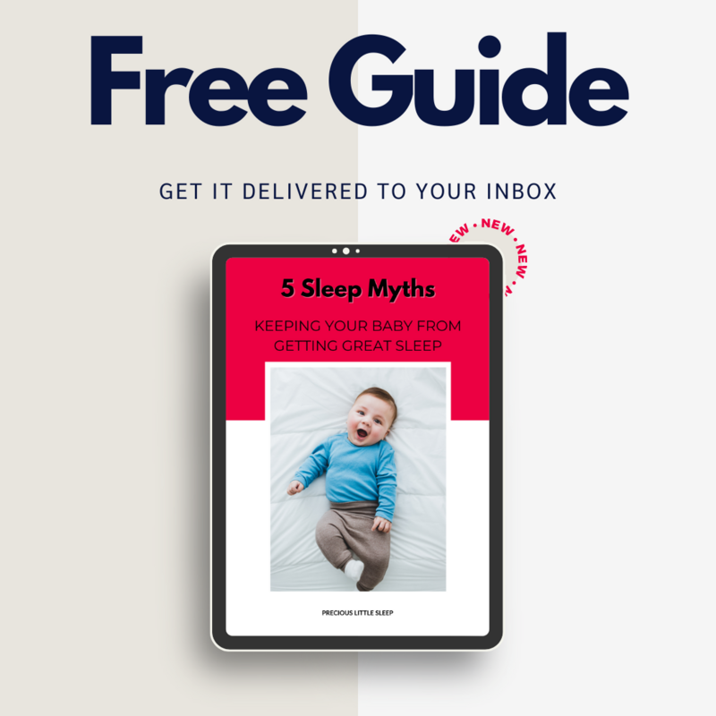 woman holding a smiling baby up in the air