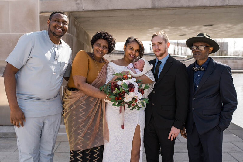 An African family smiles for portraits on wedding day near Indianapolis Canal