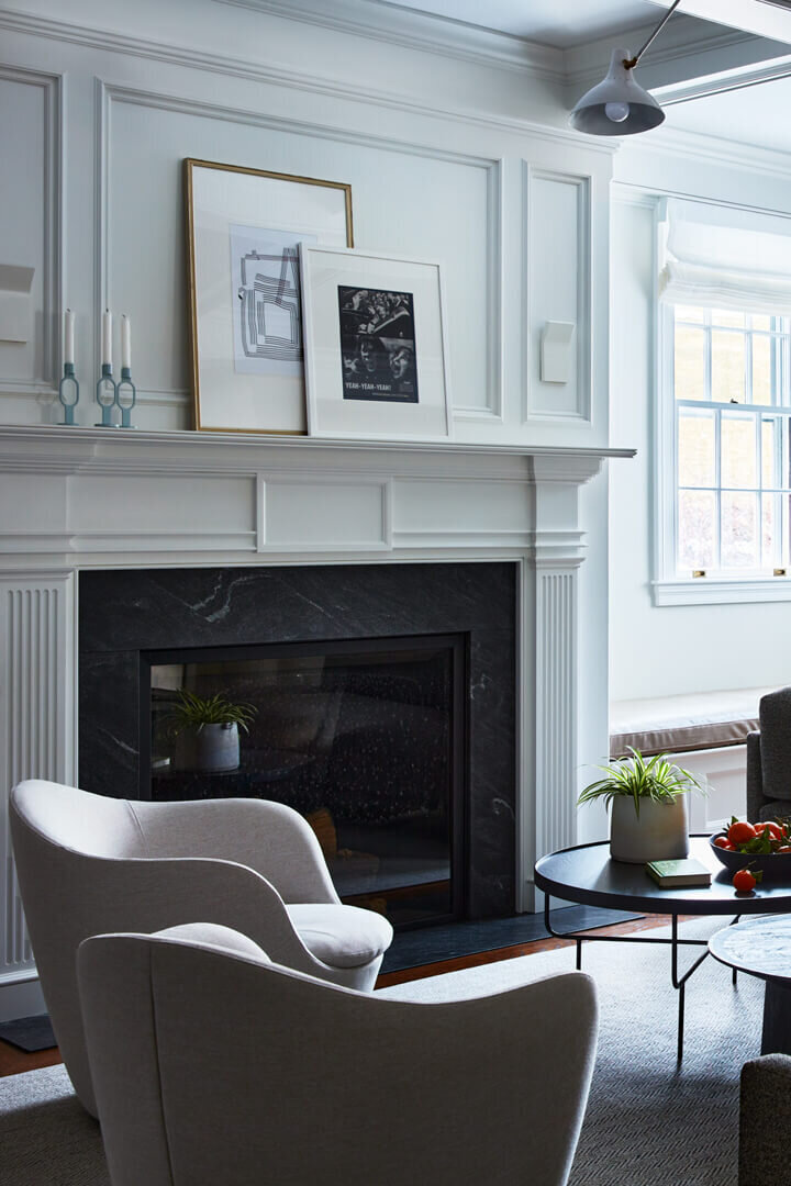 Boston interior decorator designs a modern family room in a historic Concord home, blending contemporary art with traditional architectural details.