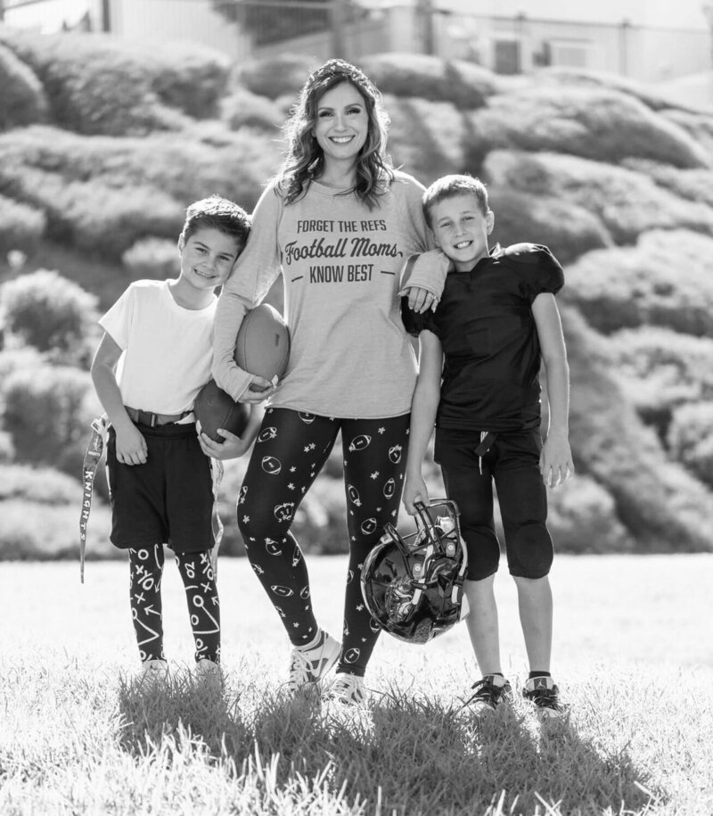 mom with her two sons in football gear