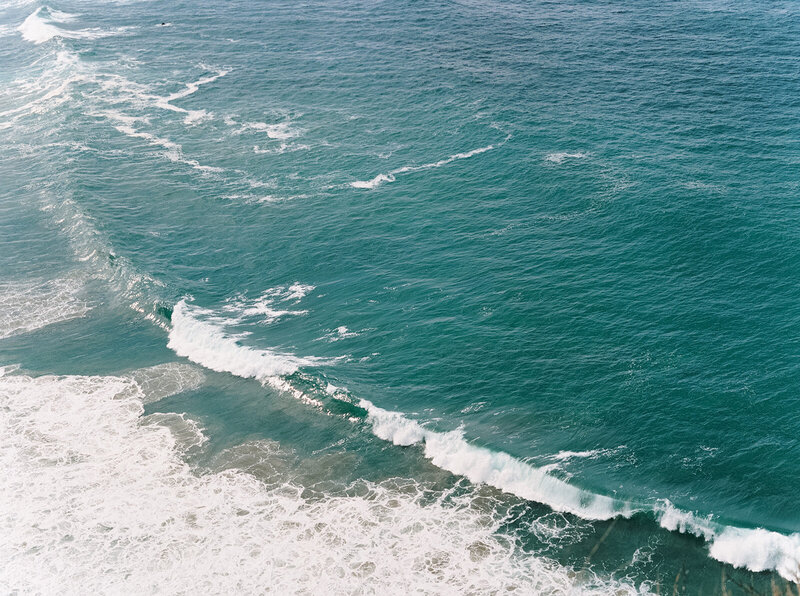 Ocean waves crashing onto shore, showcasing natural landscapes ideal for a fine art destination wedding in California.