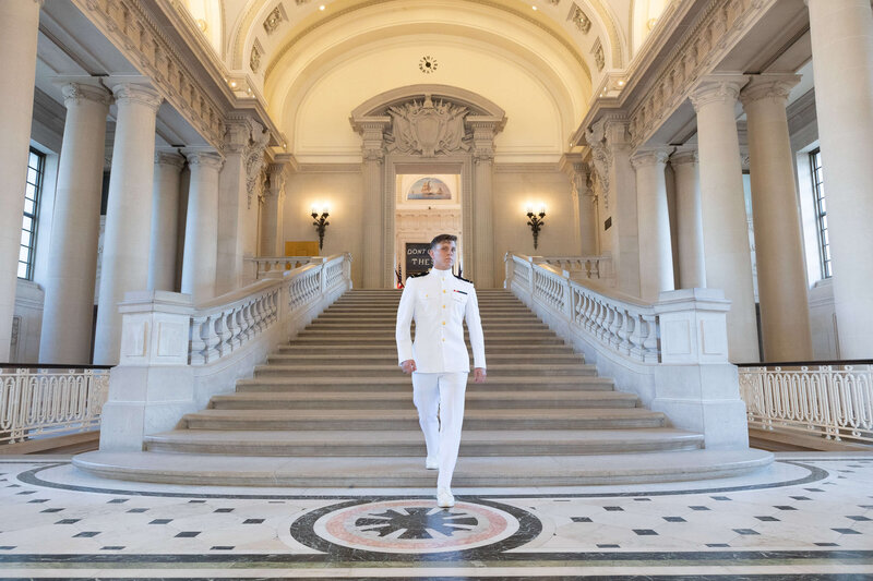 Naval Academy Midshipman walks down the stairs in the rotunda of Bancroft Hall in Annapolis Maryland