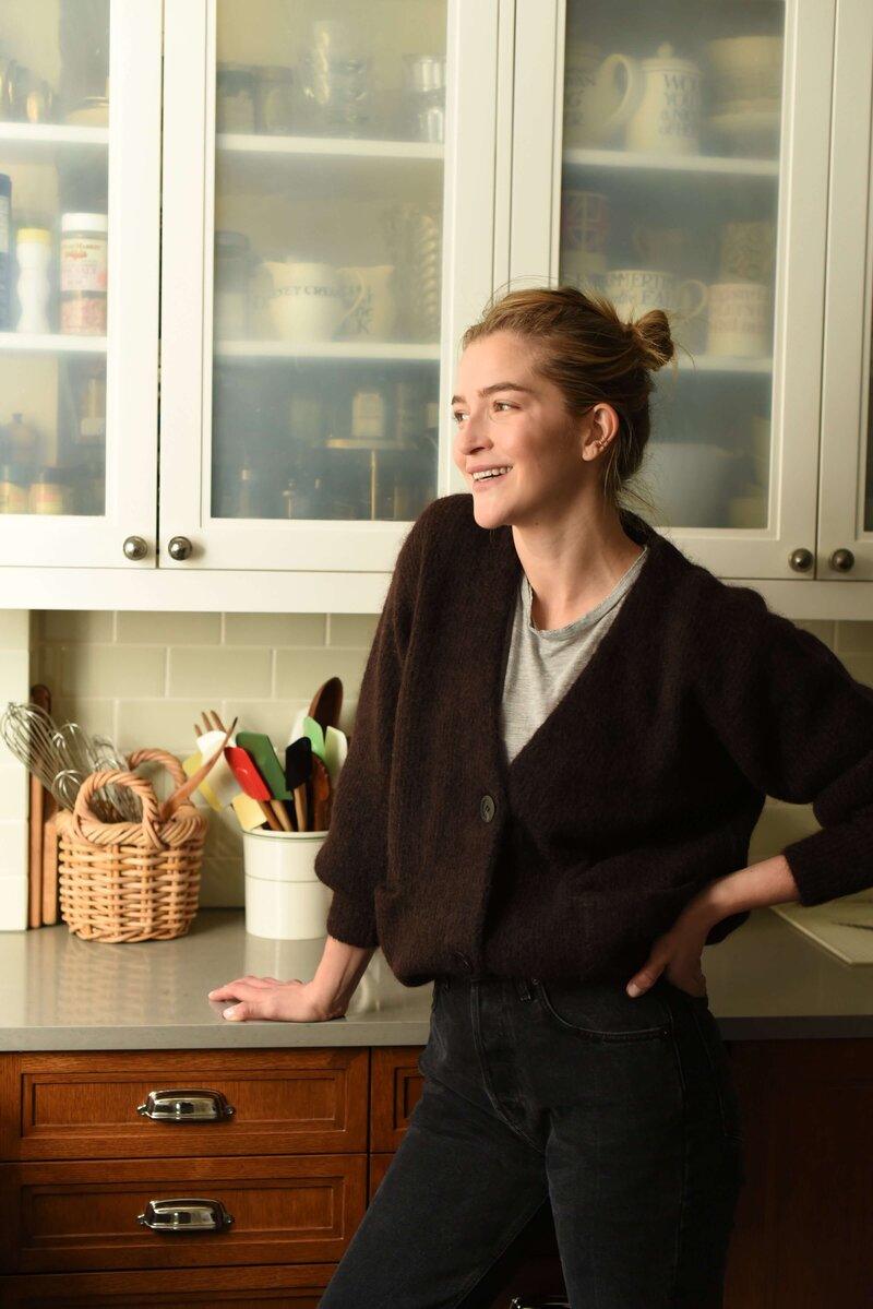 Holistic nutritionist in NYC smiling looking out window