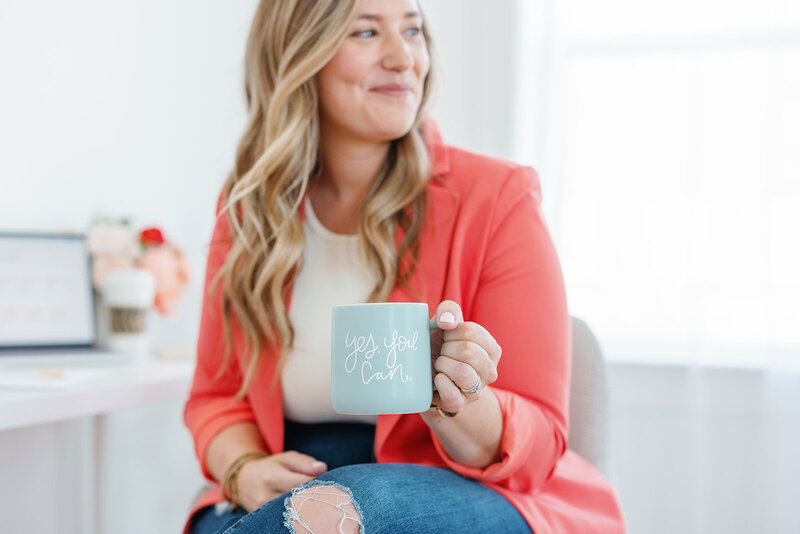 woman holding yes you can mug