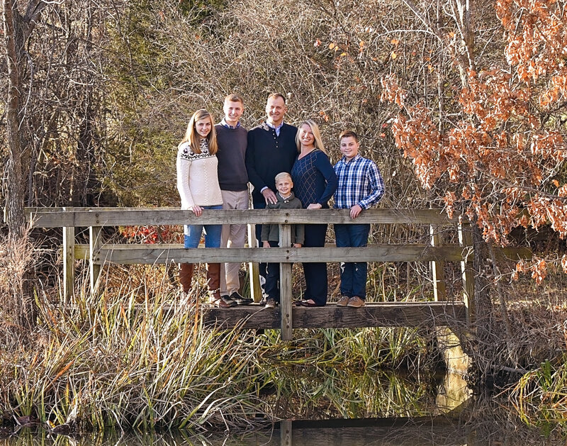 Family on footbridge over water