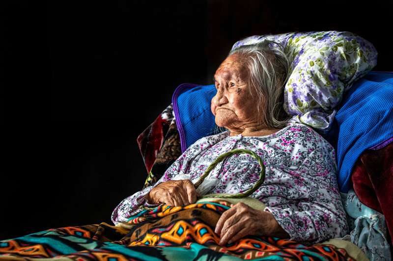 elderly indigenous woman  with sweet grass and blanket