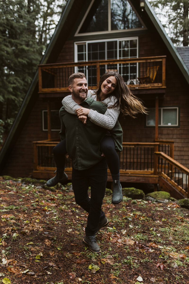 Couples Picture of Woman and Man in front of Log Cabin