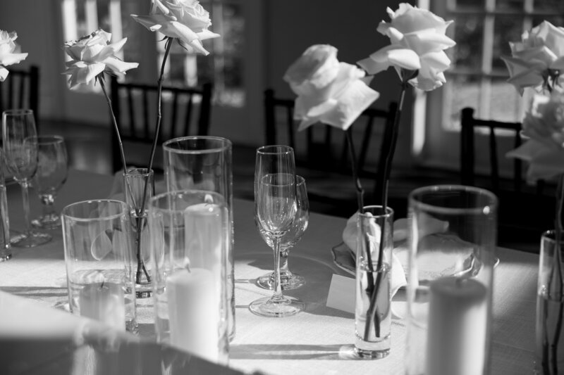 Flower vases and glassware on table in black and white