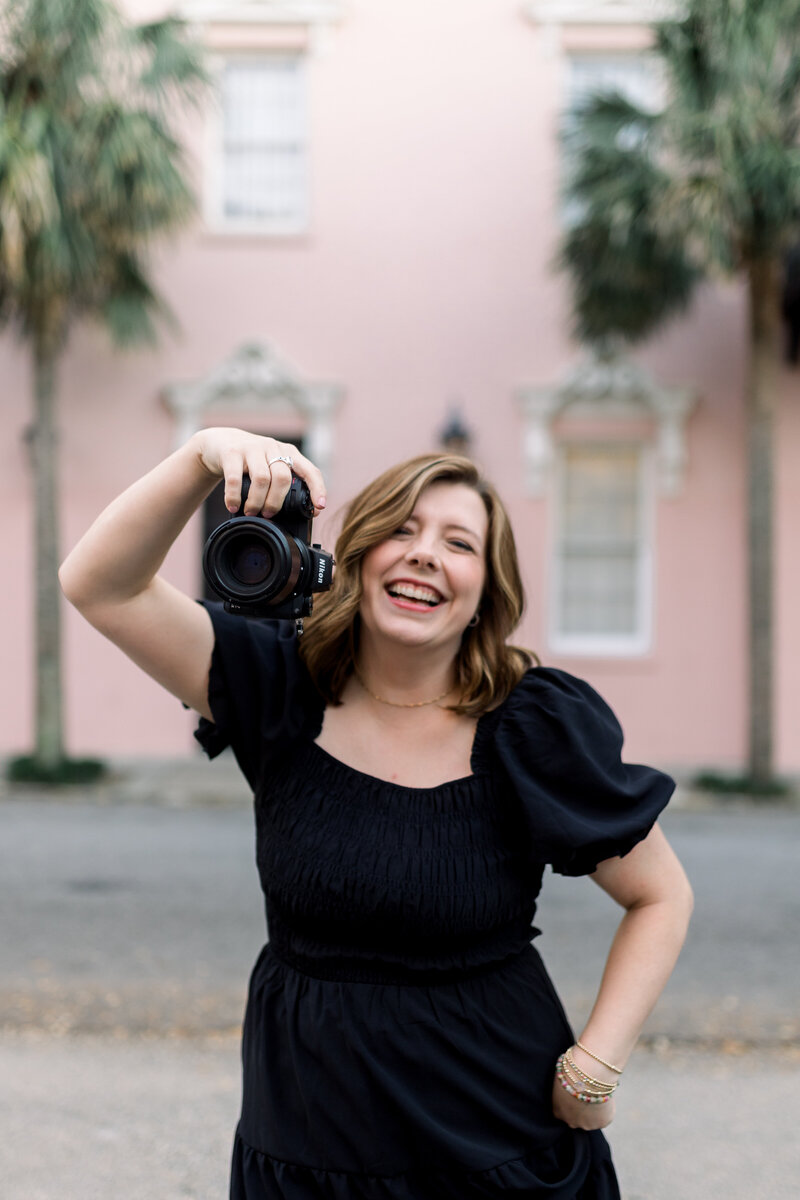 margaert hicks holding a camera in front of the mills house hotel