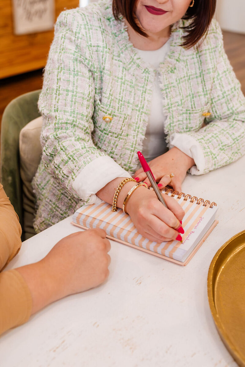 Woman writing on a notepad