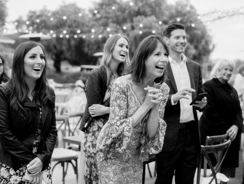 guests laughing during cake cutting at green gate ranch and vineyard in san luis obispo
