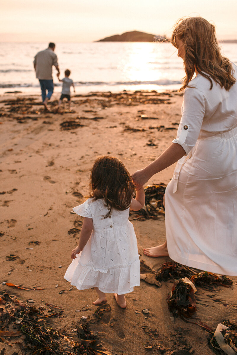 Family run ot the sea at sunset in Devon 