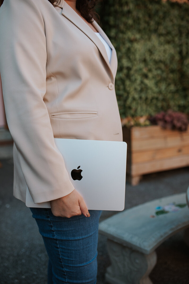Cassie Holding a Laptop