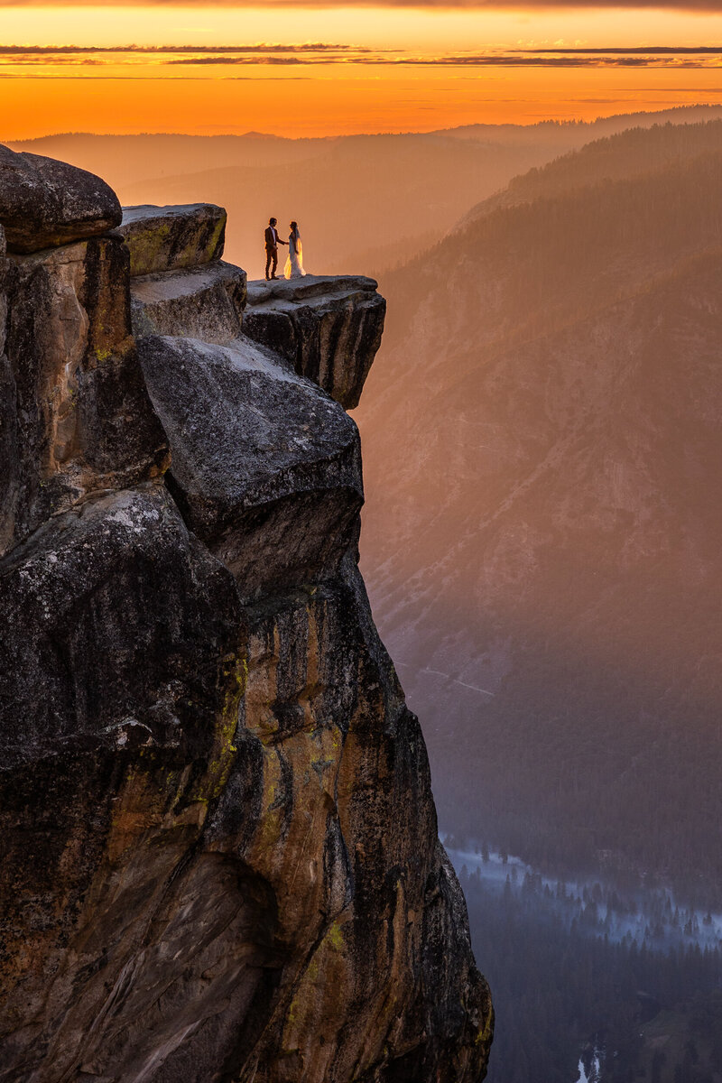 Bride and Groom facing each other at Sunset at Taft Point Yosemite