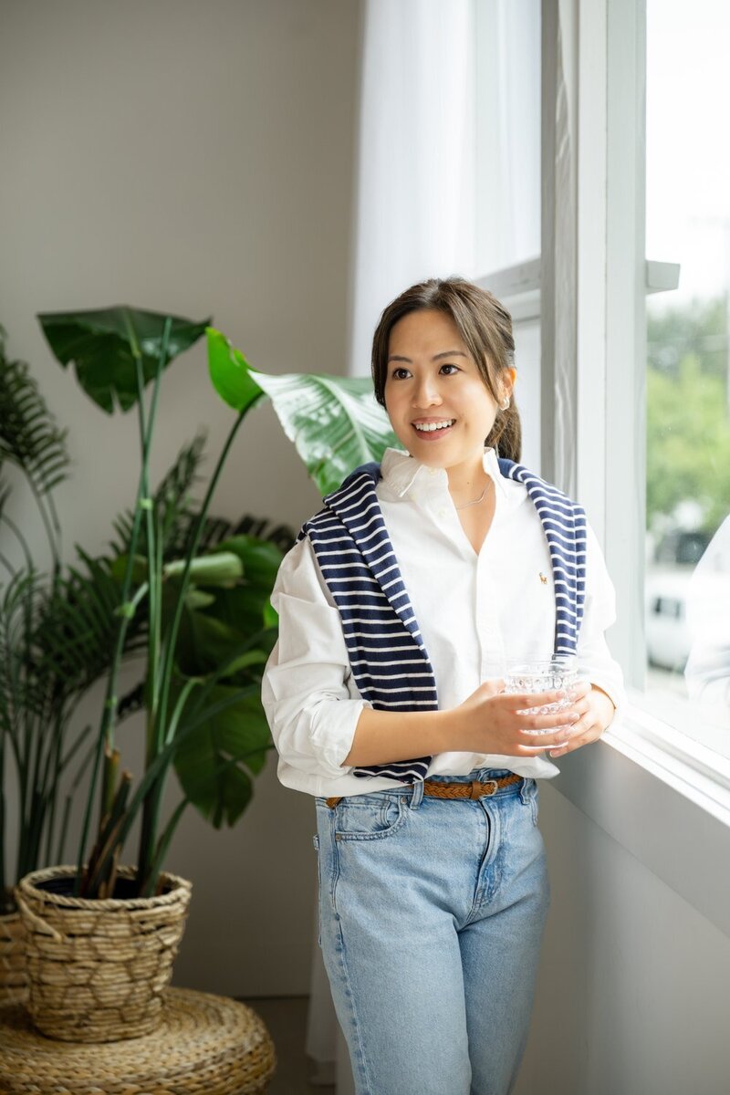 female business owner branding indoor studio at desk with computer