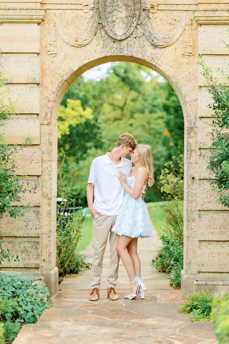 couple standing under arch in the philbrook gardens in tulsa -1