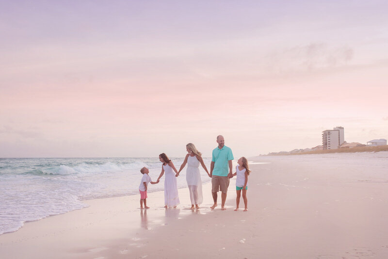 family-walking-holding-hands-on-navarre-beach