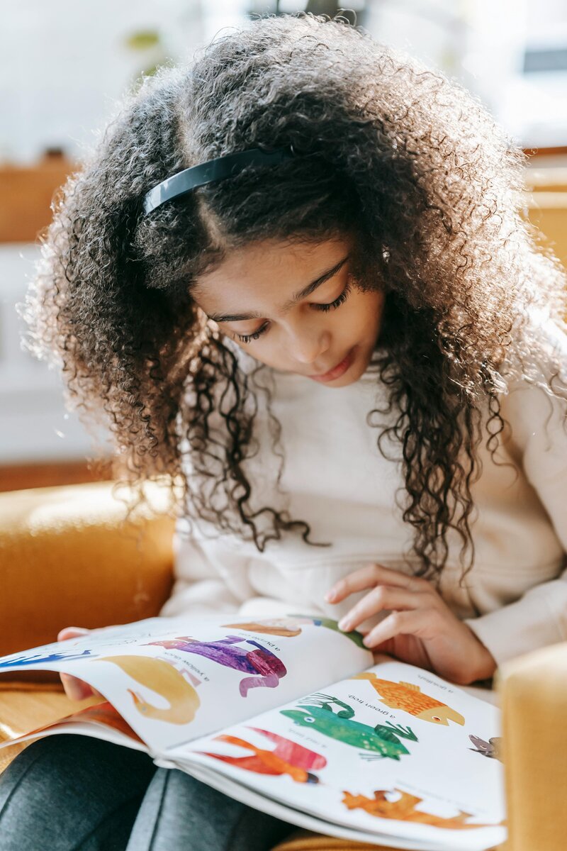 Young student reading a picture book
