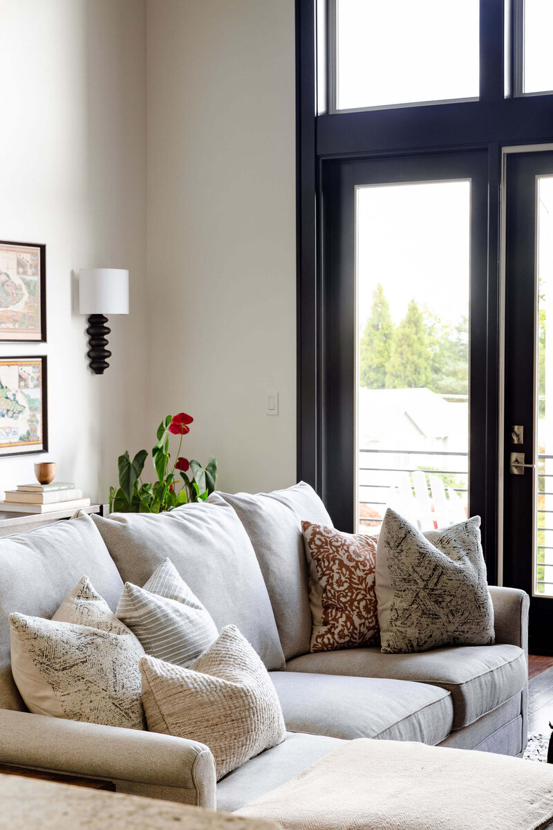 A cozy couch and throw pillows representing a modern farmhouse interior design.