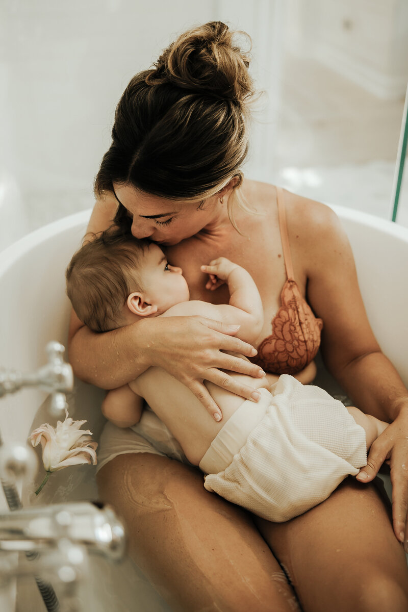Professional female photographer holding camera during branding session in natural light studio – Bedminster, NJ
