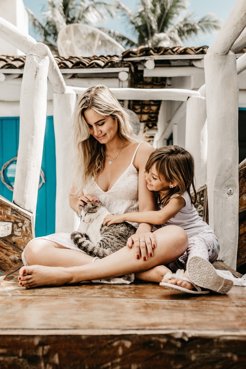 woman-and-her-child-sitting-while-holding-a-cat-2878770