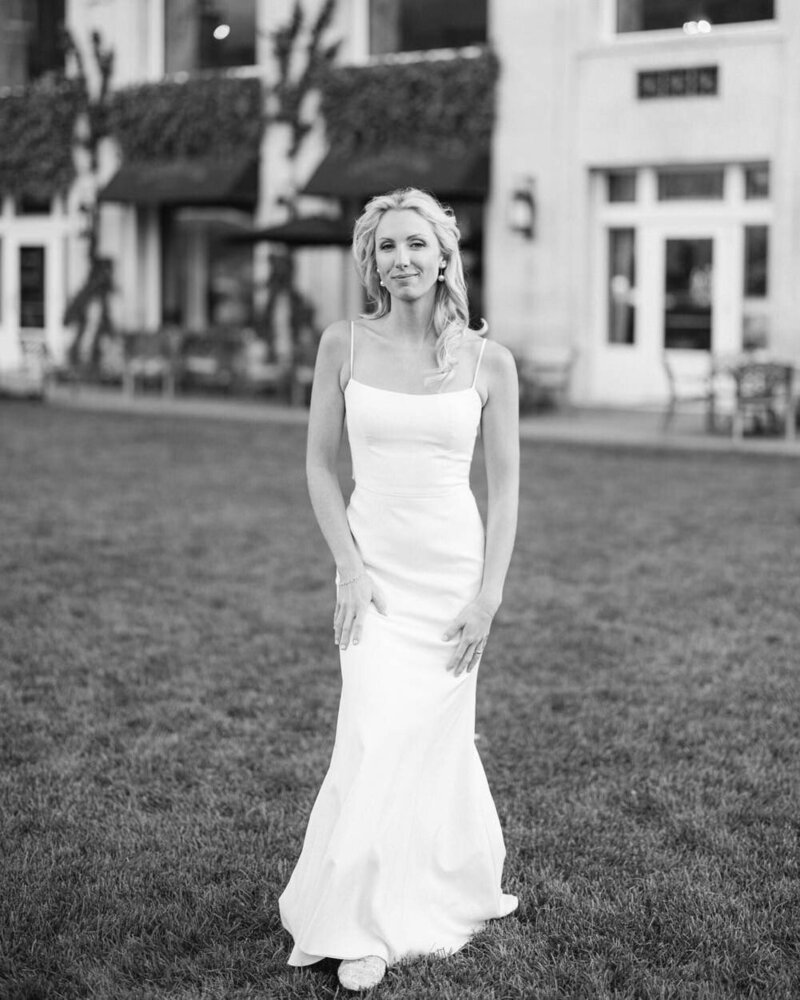 This beautiful wedding portrait captures a bride standing gracefully in her wedding dress on the lawn of the Banff Springs Hotel. Taken during the summer months near the Terrace, a popular wedding venue, the setting complements the bride’s elegance with a backdrop of natural beauty and charm.