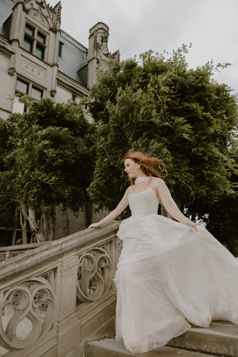 Soft romantic bridal portrait on the Biltmore Estate terrace wearing flowy anthropologie gown